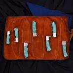 Materials: Aluminium, copper, iron, steel, wood This handcrafted 3-piece knife set features beautifully engraved Damascus-style blades and unique wooden handles with blue inlay accents. Perfect for chefs who value both artistry and performance. Includes a stylish leather carrying case. - Image 7